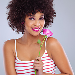 Image showing Portrait, beauty and black woman with flower in studio for skincare, floral cosmetics or dermatology on gray background. Lipstick, pink rose and female model for makeup, glowing skin and eyeshadow