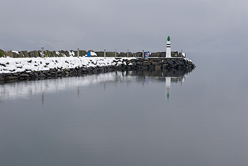 Image showing A solitary lighthouse amidst winters embrace