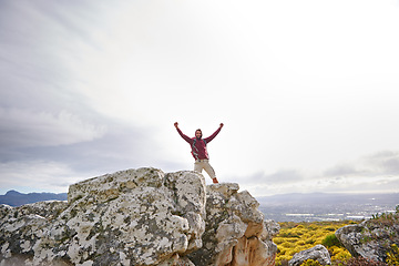 Image showing Motivation, success and man with winner on mountain, nature and rock for outdoor adventure. Male person, athlete and sport in environment for exercise, fitness and health with happiness by landscape