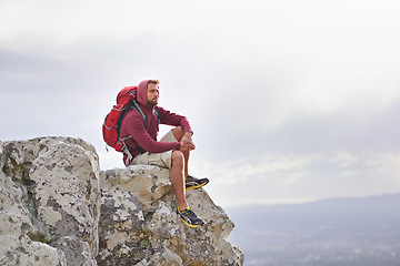 Image showing Man, cliff and thoughts on outdoor hike in nature, mountain and peace or calm on rocks for wellness. Male person, exercise and travel with backpack on vacation, thinking and explore for fitness