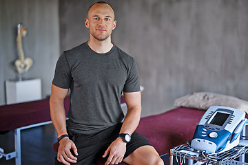 Image showing Confident, portrait or physiotherapist on bed for physiotherapy, recovery or electrotherapy with fitness. Man, trainer or proud physical therapist, consult for training and exercise or rehabilitation