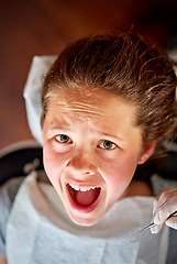 Image showing Scared, child and portrait at dentist for teeth, cleaning and fear of healthcare at clinic or hospital. Dental, care and kid afraid of tools in mouth and scream for help in medical appointment