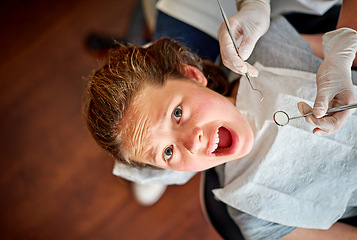 Image showing Scared, kid and portrait at dentist for teeth, cleaning and fear of healthcare at clinic or hospital. Dental, care and child afraid of tools in mouth and scream for help in medical appointment