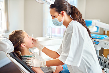 Image showing Tools, dentist and woman with child for exam, healthcare or orthodontics for teeth in clinic. Dental hygiene, kid and doctor with mask for patient, oral or cleaning mouth with medical pediatrician