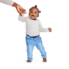 Image showing Baby girl, walking and hand in studio for help, support and balance with mockup space. Child, learning and coordination or motor skills development for steps in white background, infant care and love