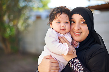 Image showing Muslim, woman and baby hug outdoor, happy in garden with mother and child for Eid celebration. Motherhood, family life and Islamic holiday with hijab, infant and smile in backyard for bonding