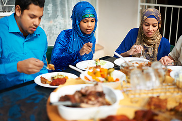 Image showing Family, eating and home with food for eid, islam and celebration around table and happy with cooking. Islamic people, man and women and together for ramadan in house for conversation and lunch