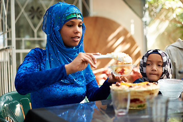 Image showing Family, muslim and table with dessert for ramadan or eid for religious holiday, celebration and eating at home. Islam, traditional and people with hijab for festival, culture and food for fasting