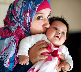 Image showing Happy, muslim and mom kiss baby in portrait at home with love and care for family in Saudi Arabia. Infant, child and Arabic mother relax in house with support and kindness of mama for kid in embrace