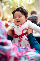 Image showing Happy, family and baby in parent arms, bonding and childcare for development and growth. Newborn, infant and relationship with kid, parenting and innocent with love and care, real and people indoor