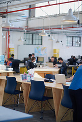 Image showing Desk, chairs and workplace for creative company, professional and copywriting people working. Laptop, technology and internet for research and typing for startup, table and wood for strong furniture