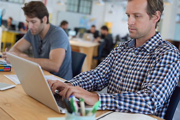 Image showing Businessman, office and desk typing on laptop for strategy, planning, research with digital technology for project. Professional, person and working on computer for online finance report on company