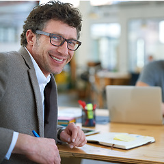 Image showing Happy, portrait and creative man in office with notebook for planning project with on desk. Mature, employee and productivity in coworking collaboration, cooperation or writing ideas in schedule