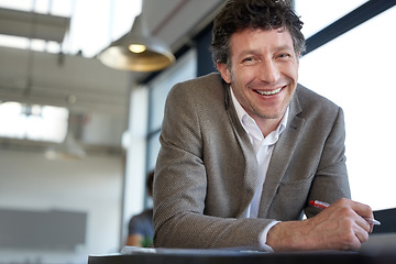 Image showing Portrait, auditor and man with smile for writing report of stock market on desk of workplace. Office, staff and male person working with pen for document, economy and budget of corporate company