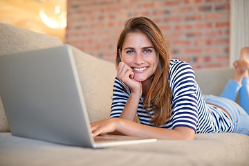 Image showing Woman, laptop and portrait for social media, website and technology for relax in house. Young person, blogger or freelancer on sofa and smile with tech for email, internet and app for online post