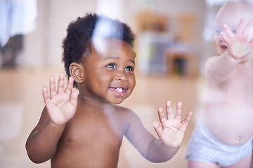 Image showing Babies, happy and standing or window, natural and child development for toddler growth in preschool. Children, sensory education and touch with hand on glass, curious play with kids together