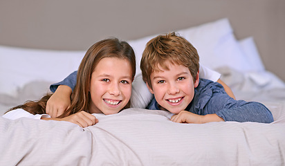 Image showing Bed, portrait and brother with sister, smile and cheerful with happiness and playful with vacation. Face, siblings and boy with girl or bonding together with bedroom and home with joy, morning or fun