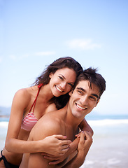 Image showing Love, hug and portrait of couple at ocean for tropical holiday adventure, relax and bonding together. Nature, man and woman smile on romantic date with beach, blue sky and embrace on happy vacation.