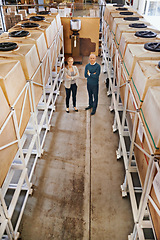 Image showing Woman, man and portrait in warehouse or packaging distribution with teamwork, wholesale or storage. People, face and factory floor for stock inventory with logistics career, production or shipment