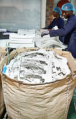 Image showing Workers, shredding and printing with paper, bag and documents for distribution, media and press. Employees, factory and publishing, industry and newspapers for magazines, books and publishers