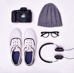 Image showing Shoes, glasses and headphones for music, fashion and camera for photographer from above view angle on studio background. Lens, beanie hat and sneakers for magazine shoot, latest style and cool shoot