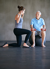 Image showing Senior man, physiotherapy and exercise ball with dumbbell for fitness, consultation and weight training with wellness. Elderly person, woman and equipment with support for rehabilitation in studio