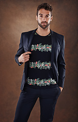 Image showing Spanish male, model and fashion portrait in studio, stylish and isolated on brown background. Clothing, confidence and backdrop space with pose, casual and trendy outfits for cool mens apparel.