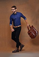 Image showing Fashion, bag and man in studio walking on background and mockup with briefcase for business vacation. Formal, style and luxury luggage for airport, journey to Italy or leather shoes with clothes