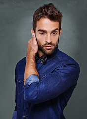 Image showing Fashionable man, model and trendy clothes in studio on grey background for clothing, isolated and confidence with style. Male person, apparel and well dressed on backdrop while touching ear.