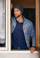 Image showing Man, window and winter fashion or thinking, house or hipster with serious male person standing in warm clothes. Beanie, head wear for comfort, indoor and cool denim jacket for trends in Canada