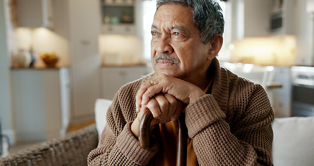 Image showing Depression, nostalgia and a senior man with a cane on a sofa in the living room of his retirement home alone. Memory, thinking and an elderly person with a walking stick in a house feeling sad