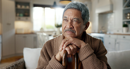 Image showing Thinking, depression and senior man with walking stick on chair with Alzheimer, memory loss or lonely. Face, anxiety and elderly male with a disability and mobility cane in living room sad or stress