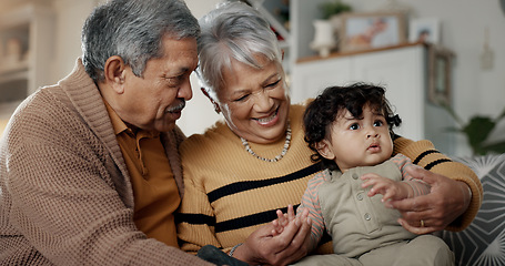 Image showing Grandparents, grandchild and home with baby, babysitting and spending quality time while bonding together, love and trust. Happy family, support and smiling on couch, retired and caring for child.