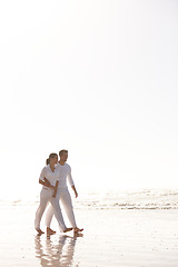 Image showing Couple, walking and beach with hug for love, embrace or valentines day in outdoor nature. Man and woman enjoying stroll by the ocean coast or sea for holiday, date or weekend together on mockup space