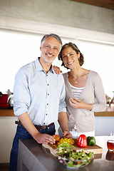 Image showing Mature couple, portrait or cooking in kitchen with support, salad bowl or vegetables for healthy meal. Man, woman and smile at table with preparation for dinner, lunch or nutrition in home with relax