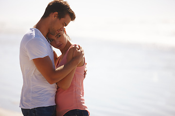 Image showing Couple, hug and comfort at beach with empathy, sad woman and man with love, care and time together outdoor. Safety, security and trust for comfort or support with compassion in relationship