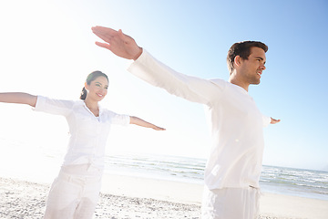 Image showing Balance, yoga and couple on beach for fitness, calm and wellness with sunshine, travel and mindfulness together. Calm, peace and natural light with fresh air, happy people and energy balance for aura