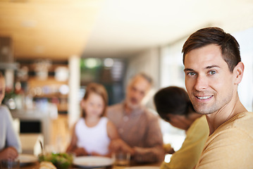 Image showing Portrait, home and man with family for lunch, bonding and eating together at table with smile. Dining room, happy people and face of male person with food, celebration and thanksgiving in house