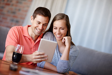 Image showing Couple, relax and happy in home with tablet for streaming online for movies or films, videos and social media memes. Man, woman and together with love for bonding or embrace with care and support