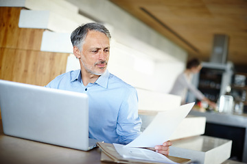 Image showing Mature, businessman and laptop for remote work with document and reading or online research for project. Entrepreneur, computer and paperwork on startup company and learning for small business growth