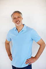 Image showing Portrait, confidence and smile of senior man on brick wall for fashion isolated on a white background in Switzerland. Face, mature and happy person in casual clothes, shirt and positive for style