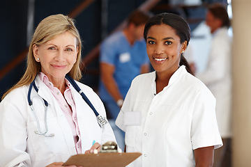 Image showing Doctor, women and teamwork portrait in healthcare with clipboard, health information and smile in hospital. Medical partnership, professional and cardiology career for support, trust and diversity