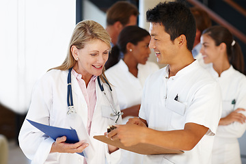 Image showing Doctors, medical and team in hospital with clipboard for results, discussion and health for nurse. Diverse people colleagues or medic for healthcare, expert and medicine for planning and research