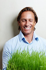 Image showing Businessman, smile and nature with grass in office for ecology, climate and environment. Male person, clean energy and corporate with plant by background for turf, sustainability and eco friendly