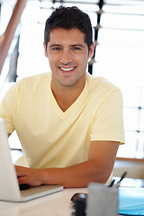 Image showing Man, smile and portrait with laptop in office for internet, research online and website for company. Young person, editor and happy with tech for typing, email and creative project for work and job