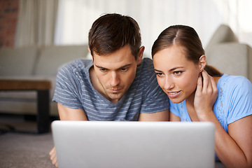 Image showing Couple, woman and man with laptop, search and relax with partner, girl and girlfriend on floor of home. Vacation, internet and female person browsing online for resort or hotel for date in holiday