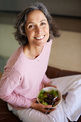 Image showing Mature woman, couch and smile with salad or vegetables for diet, nutrition and health at home. Female person, sofa and happy in living room as vegetarian on break, relax and portrait from above