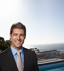 Image showing Business man, suit and portrait with sky, space and outdoor on balcony with pride, smile and mockup by sea. Person, corporate employee and happy in summer, sunshine and ocean on rooftop in New York