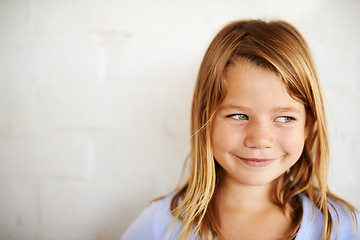 Image showing Children, thinking or girl smile for idea, planning or brainstorming in house with questions on wall background. Solution, why or kid person at home for problem solving, learning or child development