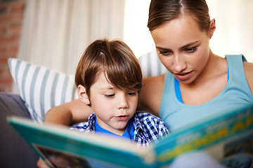 Image showing Home, book and mother with kid, son or education with storytelling or bonding together in lounge. Family, apartment or mama with boy, creative or child development with reading, relaxing or knowledge